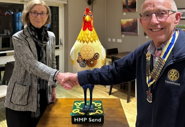 Haslemere Rotary president Paul Mills, right, presents the hen to Sally Varah