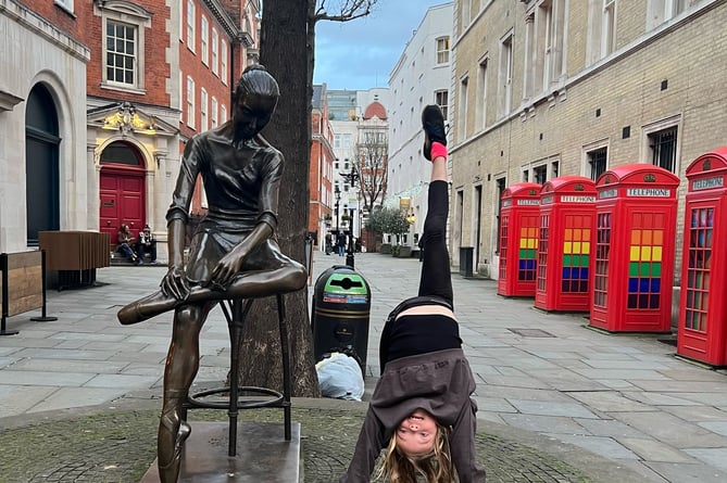 Ava in the process of doing front and back walkovers