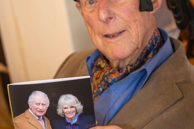 John with his card from Charles and Camilla