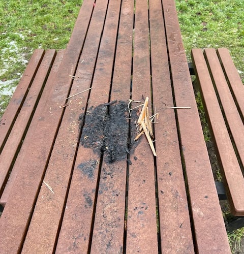 The damaged picnic bench in Lion Green after another fire started by vandals