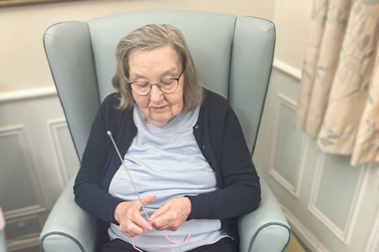 Susan Osbourne, a resident at Redcot Residential Care Home in Haslemere, enjoying a Knit and Natter Group session